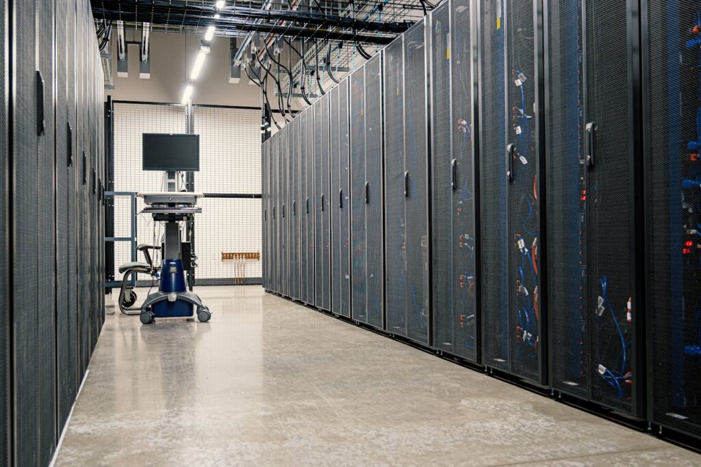 pexels photo 4508751 Modern data center corridor with server racks and computer equipment. Ideal for technology and IT concepts.