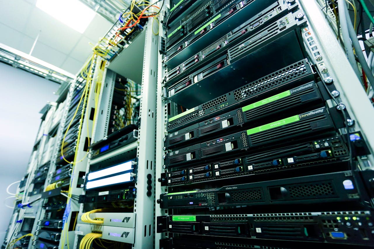 hero-img-02 High-tech server rack in a secure data center with network cables and hardware components.